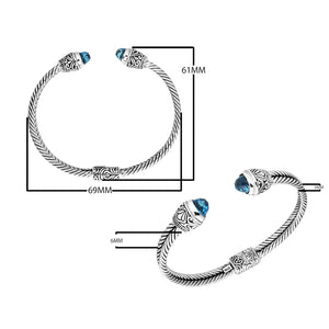 Sterling silver wholesale bangle with twisted rope design, accented by Blue Topaz Quartz and Balinese handcrafted motifs.