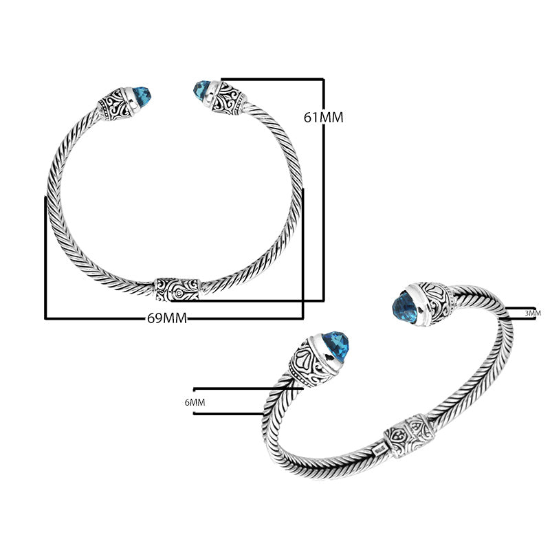 Sterling silver wholesale bangle with twisted rope design, accented by Blue Topaz Quartz and Balinese handcrafted motifs.