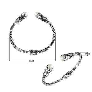 Sterling silver twisted bangle with pearl ends and Balinese carvings, handcrafted in Bali