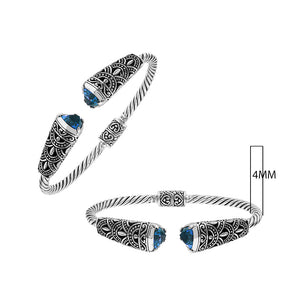 Sterling silver twisted bangle with blue topaz quartz ends and oxidized Balinese design