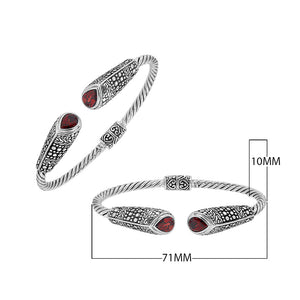 Sterling silver twisted bangle with garnet quartz ends and Balinese oxidized dot pattern