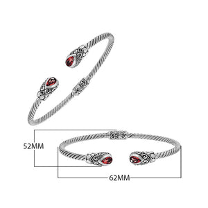 Silver twisted cable bangle in 925 sterling silver with pear-shaped Garnet Quartz and Balinese scroll engraving.