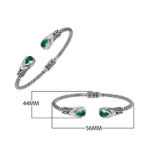Silver twisted cable bangle in 925 sterling silver with Green Quartz ends and Balinese engraving.