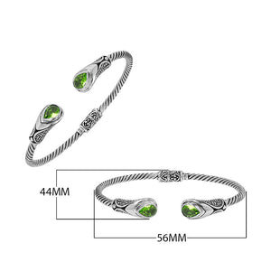 Silver twisted cable bangle in 925 sterling silver with Peridot Quartz ends and Balinese engraving.