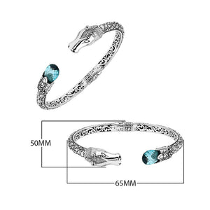 Sterling Silver Dragon Head Bangle with Blue Topaz Quartz handcrafted in Bali featuring intricate filigree and oxidized detailing.
