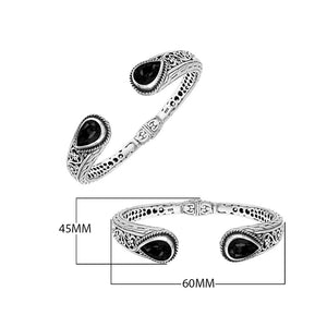Wholesale sterling silver cuff with black onyx teardrop stones and ornate Balinese carving.
