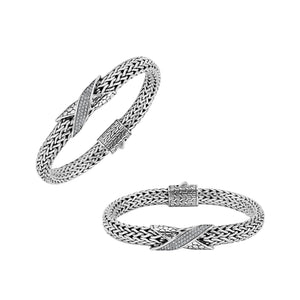 Sterling Silver woven bracelet featuring a polished push clasp and a sparkling Cubic Zirconia crisscross centerpiece, designed with durable construction and fine detailing for professional wholesale presentation.