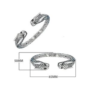 Wholesale sterling silver phoenix cuff bangle featuring Abalone Shell accents, intricate Balinese scroll engraving, and a secure hinge lock for detailed artisan presentation.