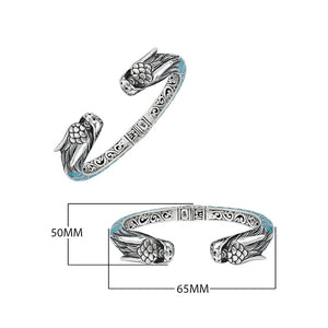 Wholesale sterling silver phoenix bangle featuring Turquoise Shell accents, ornate Balinese scroll engravings, and a secure hinge lock crafted for premium artisan wholesale jewelry collections.