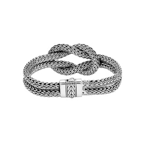 Wholesale sterling silver multi-strand woven knot bangle featuring a thick Balinese-style chain weave and a secure push clasp for premium artisan jewelry displays.