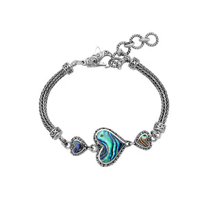 Wholesale sterling silver bracelet featuring Abalone Shell heart links, intricate Balinese decorative detailing, and a secure lobster lock for premium artisan-style jewelry collections.