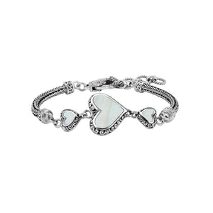 Wholesale sterling silver bracelet featuring Mother Of Pearl heart motifs, ornate Balinese decorative details, and a secure lobster lock for premium artisan-inspired jewelry assortments.