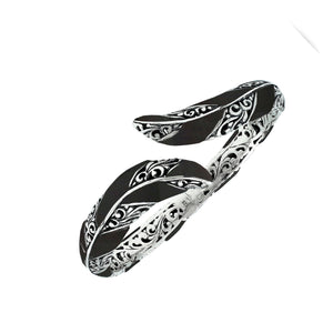 Wholesale sterling silver feather-inspired bangle featuring bold Black Shell inlays, ornate Balinese scroll engraving, and a secure hinge lock for premium artisan-inspired jewelry collections.