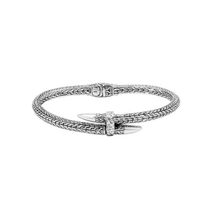 Wholesale sterling silver woven chain bangle featuring a sculpted nail-head design, intricate Balinese engravings, and a secure hinge lock for premium artisan jewelry assortments.