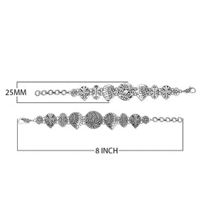 Wholesale sterling silver link bracelet featuring multiple carved Balinese motif shapes, intricate scroll engravings, and a secure lobster lock for premium artisan jewelry assortments.