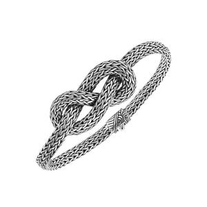 Wholesale sterling silver woven knot bracelet featuring detailed chainwork, oxidized highlights, and a secure push clasp, ideal for premium handcrafted jewelry assortments and boutique suppliers.
