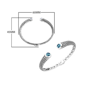 Wholesale sterling silver Bali engraved hinge cuff bracelet featuring bright blue topaz quartz accents with polished–oxidized artistry, crafted for premium wholesale jewelry inventory needs.