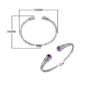 Wholesale sterling silver Bali engraved hinge cuff bracelet featuring polished–oxidized detailing and brilliant amethyst quartz ends, crafted to enhance premium wholesale jewelry collections with artistic detail.