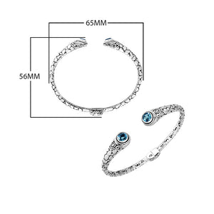 Wholesale sterling silver Bali engraved hinge cuff bracelet featuring polished–oxidized detailing and radiant blue topaz quartz ends, expertly crafted for refined contemporary wholesale jewelry assortments