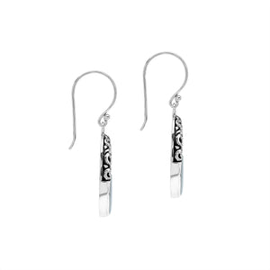 Sterling silver oval drop earrings featuring luminous Mother Of Pearl inlay, open center silhouette, decorative scrollwork, oxidized detailing, polished borders, and French ear wires.