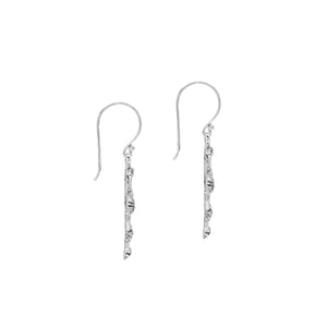 Sterling silver cross drop earrings featuring open oval sections, sculpted floral motifs, oxidized detailing, polished raised accents, and classic French ear wires.