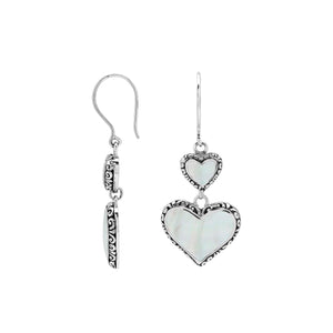 Wholesale sterling silver earrings featuring double mother of pearl heart drops with ornate decorative borders, crafted to deliver consistent artisan quality and elegant catalog-ready presentation for bulk jewelry buyers.