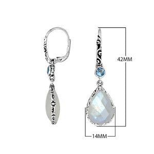 Wholesale sterling silver earrings featuring a faceted Rainbow Moonstone teardrop and Blue Topaz Quartz accent with ornate scroll designs and secure earwire, ideal for premium catalog displays.