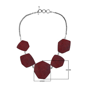 Sterling silver necklace with hexagon-shaped red coral links, polished artisan finish.
