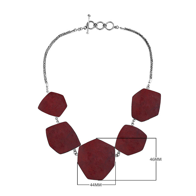 Sterling silver necklace with hexagon-shaped red coral links, polished artisan finish.