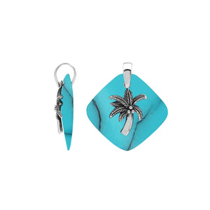 Sterling silver palm tree pendant on turquoise diamond-shaped base, handmade in Bali for wholesale jewelry buyers.