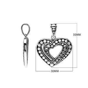 Sterling silver heart-shaped pendant featuring layered open-heart design, dotted Balinese pattern, and oxidized polished finish.
