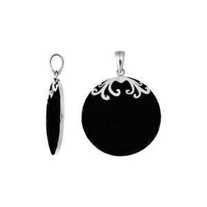 Sterling silver round Black Shell pendant featuring a glossy jet-black circular surface, symmetrical silver floral scrollwork across the upper edge, and a polished tapered bail, displayed in front and side views.