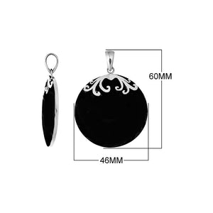 Sterling silver round Black Shell pendant featuring a glossy jet-black circular surface, symmetrical silver floral scrollwork across the upper edge, and a polished tapered bail, displayed in front and side views.