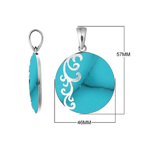 Sterling silver round Turquoise Shell pendant featuring vibrant turquoise blue color, subtle dark veining, decorative floral scrollwork along one side, and a polished silver bail.