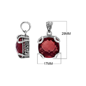 Sterling silver cushion pendant featuring a deep-toned Red Garnet Quartz center secured with artistic prong detailing and traditional Balinese carved accents.