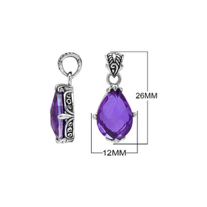 Sterling silver pear-shaped pendant featuring a faceted Amethyst Quartz centerpiece with polished prong-setting and traditional Balinese carved ornamental accents.