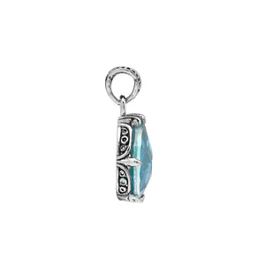 Sterling silver pear-shaped pendant featuring a faceted Blue Topaz Quartz centerpiece with polished prong-setting and intricate Balinese carved detailing.