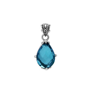 Sterling silver pear-shaped pendant featuring a faceted London Blue Topaz Quartz center with polished prong-setting and traditional Balinese carved ornamental detailing.