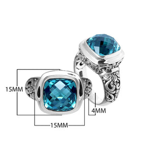 Sterling silver ring with cushion-cut Blue Topaz Quartz and Balinese scroll carvings.