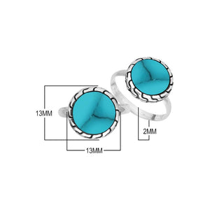 Sterling silver round Turquoise Shell statement ring featuring a vibrant blue centerpiece, sculpted decorative border, oxidized detailing, and polished silver band.