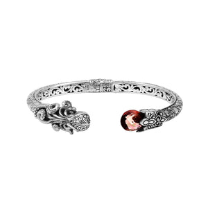 Sterling silver dragon head cuff bangle with garnet quartz ends and floral carvings handcrafted in Bali.