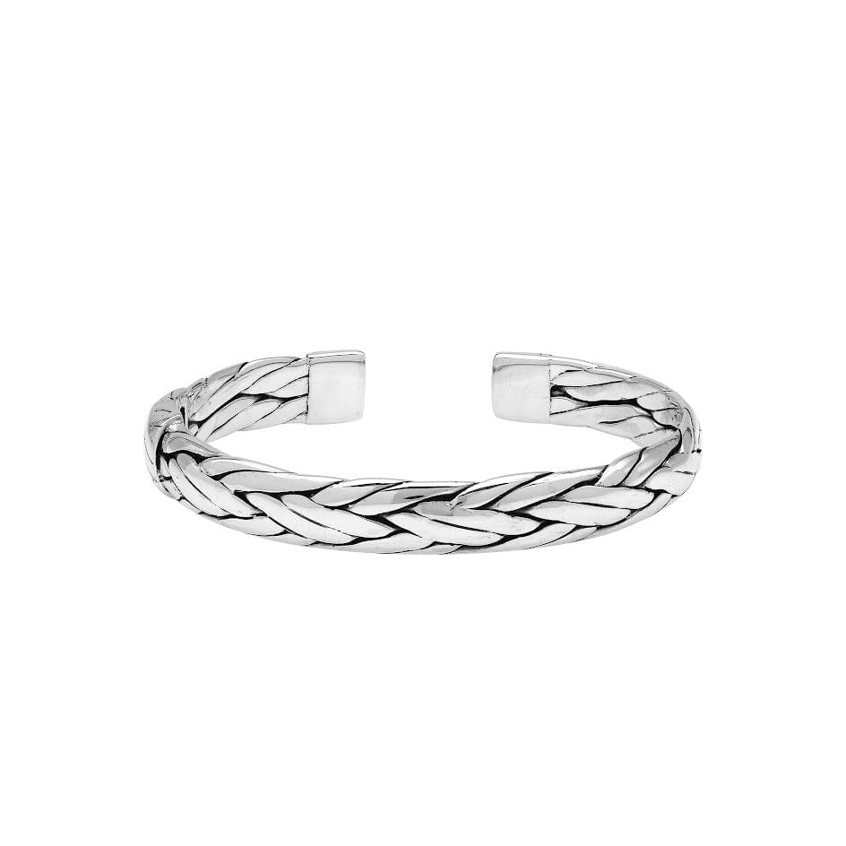 A wholesale sterling silver large woven bangle featuring bold Balinese textures, polished detailing, and a secure hinge lock, ideal for premium bulk jewelry purchasing.