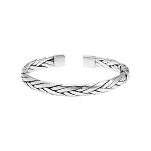 A wholesale sterling silver small woven bangle featuring polished Balinese textures, smooth finishing, and a secure hinge lock perfect for lightweight premium jewelry collections.