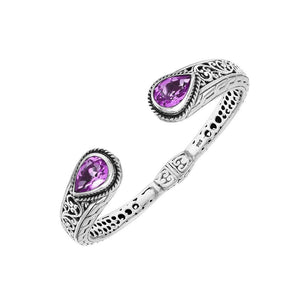 Sterling silver bangle featuring teardrop amethyst quartz stones, detailed Bali engraving, oxidized texture, and a secure hinge lock designed for premium wholesale jewelry collections.