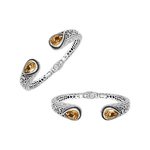 Sterling silver bangle featuring teardrop citrine quartz stones, ornate Bali engraving, oxidized accents, and a secure hinge lock made for premium wholesale jewelry collections.