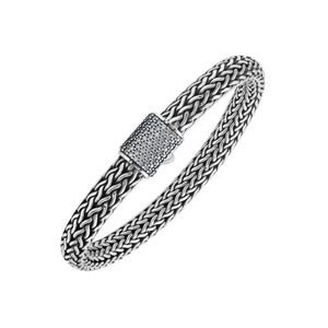 A wholesale sterling silver broad woven bracelet featuring a CVD Diamond-studded push clasp, polished and oxidized detailing, and bold craftsmanship designed for premium bulk jewelry collections.