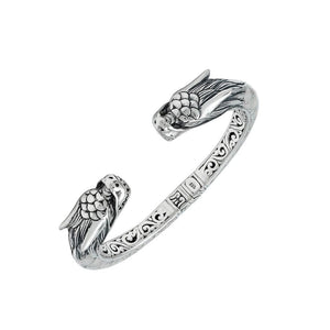 Wholesale sterling silver phoenix bangle featuring Mother of Pearl accents, detailed Balinese scroll carving, and a secure hinge lock ideal for premium artisan jewelry collections.