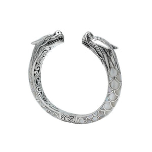 Wholesale sterling silver phoenix bangle featuring Mother of Pearl accents, detailed Balinese scroll carving, and a secure hinge lock ideal for premium artisan jewelry collections.