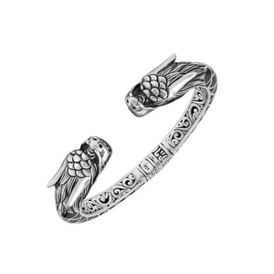 Wholesale sterling silver phoenix bangle featuring Black Shell insets, ornate Balinese scroll carving, and a sturdy hinge lock, crafted for premium artisan wholesale jewelry assortments.