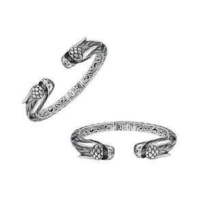 Wholesale sterling silver phoenix bangle featuring Black Shell insets, ornate Balinese scroll carving, and a sturdy hinge lock, crafted for premium artisan wholesale jewelry assortments.